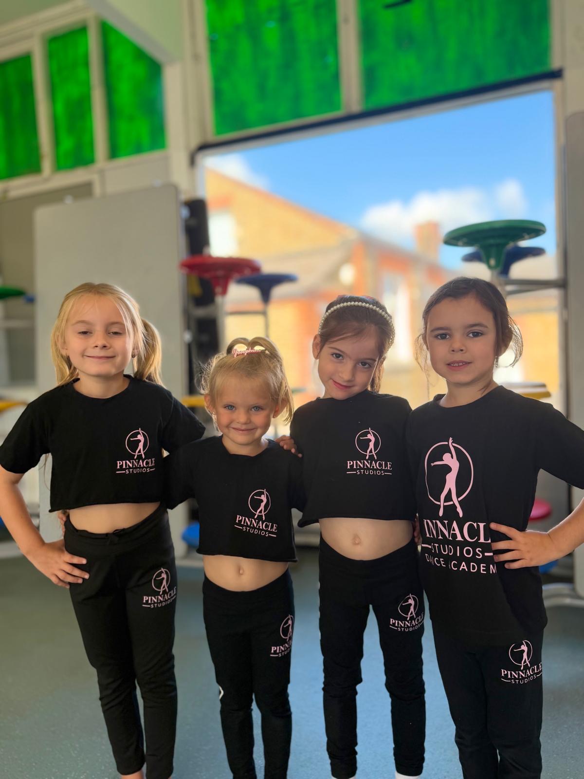 Four young Pinnacle dancers together in academy uniform