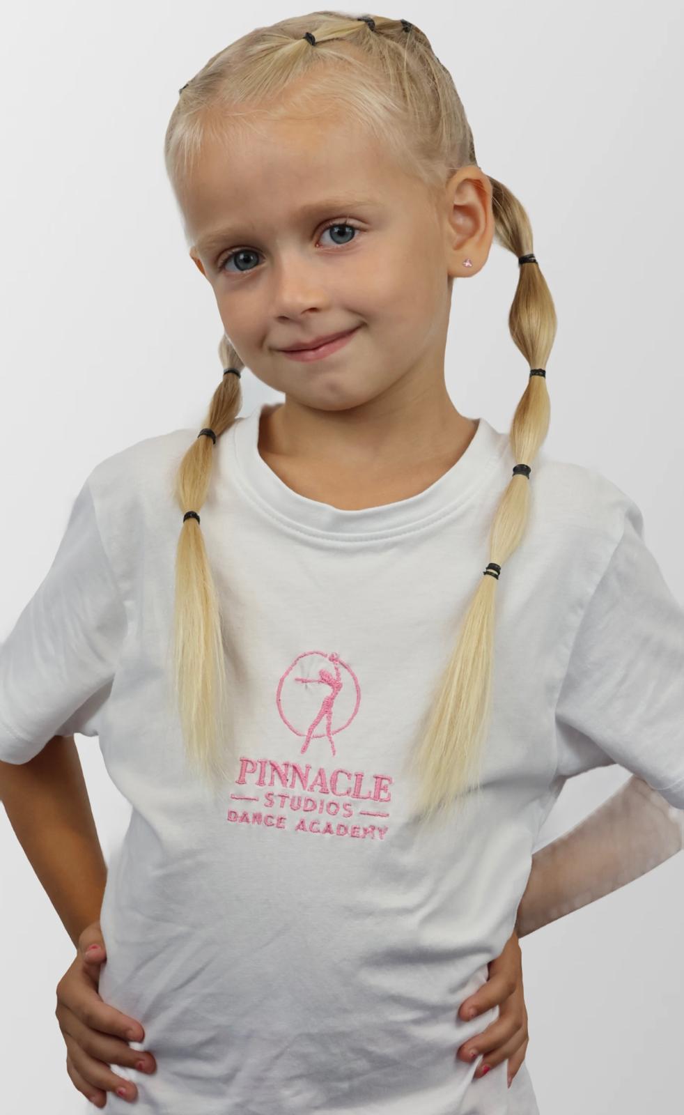 A young Pinnacle Studios dancer wearing the academy T-shirt